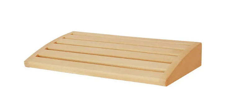 The wooden headrest for the SENTIOTEC sauna helps for maximum relaxation