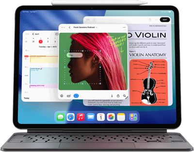iPad Air zobrazující plochu s různými aplikacemi Apple, spárovaný s Magic Keyboardem a Apple Pencilem Pro