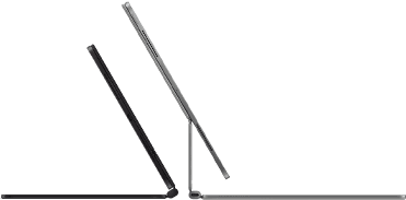 Dva iPady Pro připnuté k Magic Keyboardu, pohled z boku, tenký profil, vesmírně černá barva, reproduktory a USB‑C port, jeden napůl otevřený, druhý ve stříbrné barvě otevřený a nakloněný dozadu, takže je vidět plovoucí konzolová konstrukce klávesnice, reproduktory a mikrofon