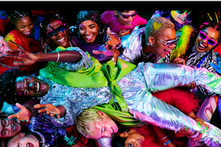 MacBook Pro with a colourful image of a person crowd-surfing at a party to showcase the rich colours of the Liquid Retina XDR display