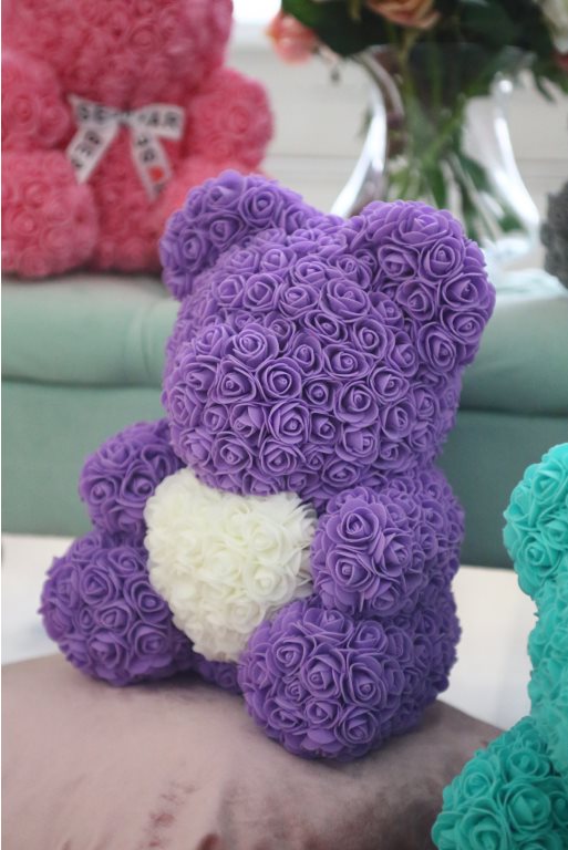 Purple bear with store white rose